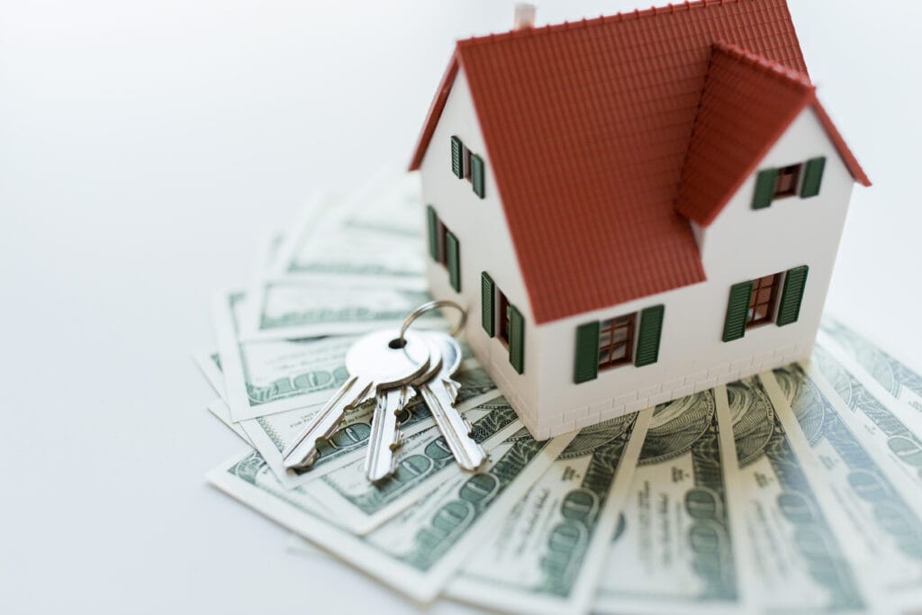 Model house with keys and cash